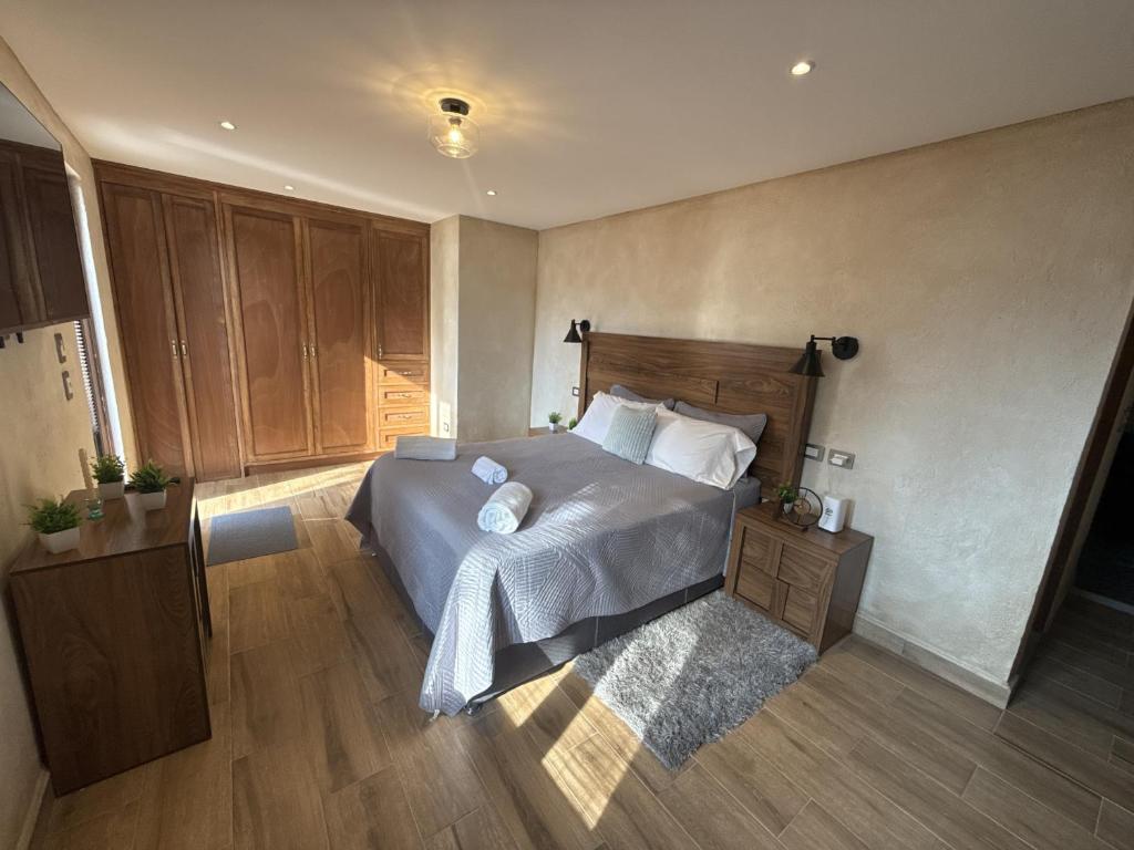 a bedroom with a bed and a wooden floor at Loft Elena en ValQuirico in Santeagueda