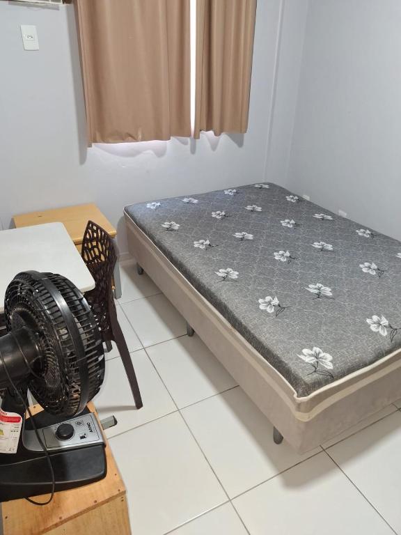 a room with a bed and a camera on a table at Hortelã Miranda in Caruaru