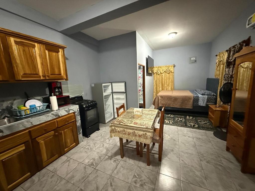 a kitchen with a table and a bed in a room at Tees Place in Hopkins
