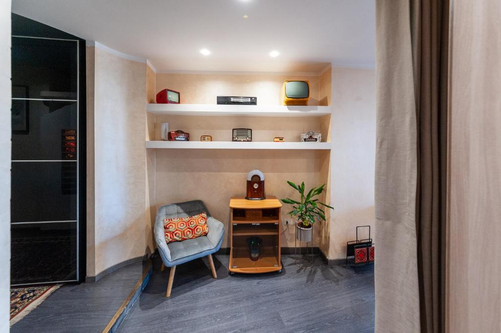 a living room with a chair and a table at AuraVista in Montefiascone