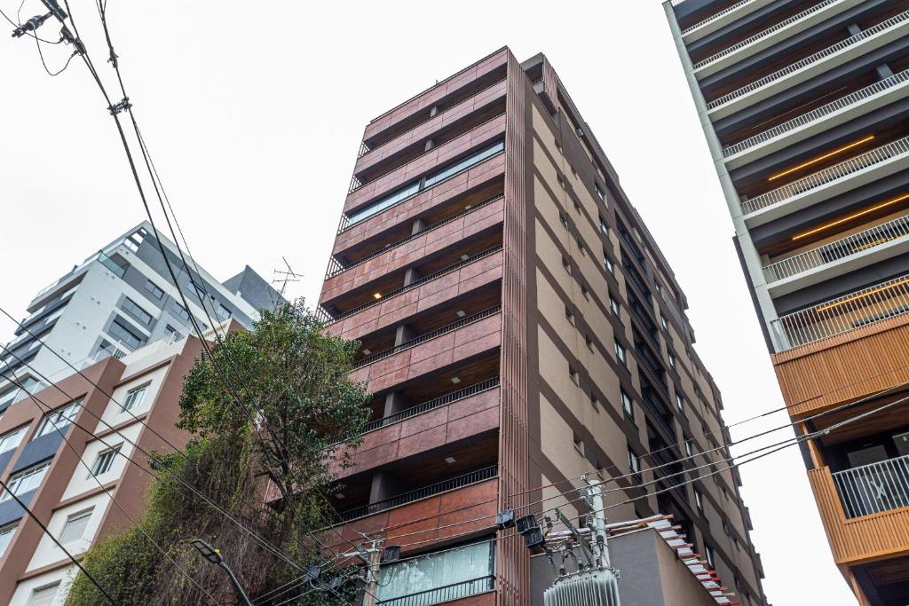 a tall building in the middle of some buildings at Next Paulista by Viva - Apartamentos completos ao lado da Av Paulista e MASP in São Paulo
