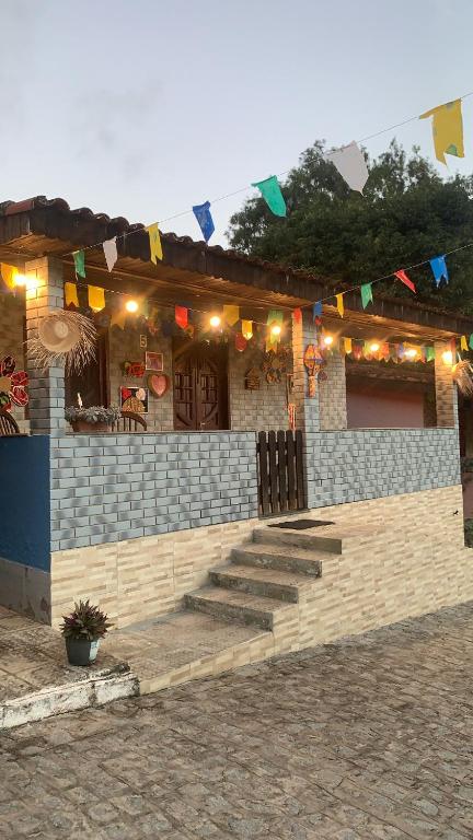 a building with flags and stairs in front of it at Casa Gravatá Próximo ao Centro in Gravatá