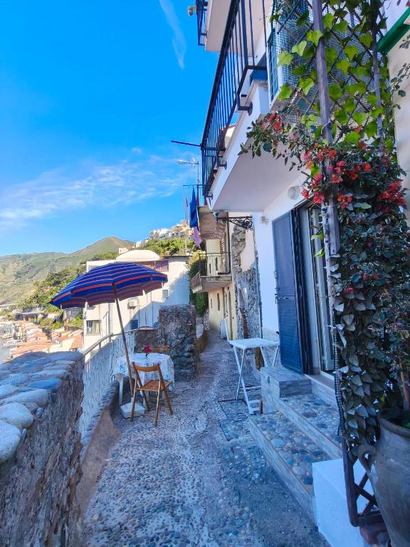an alley with a table and an umbrella at Scilla Chianalea Suite Mare1 in Scilla