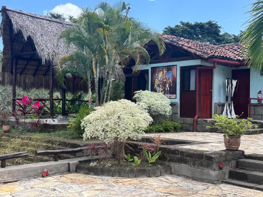 a house with a palm tree in front of it at Casa Maya Lodge in Masatepe