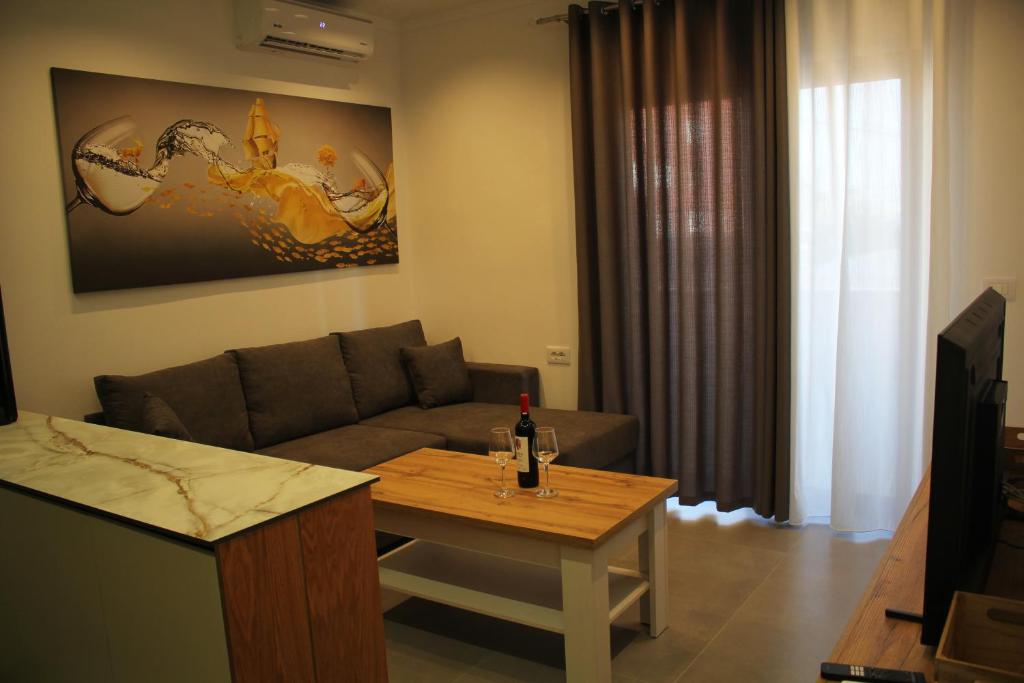 a living room with a couch and a table at Lazari S Apartments in Himare