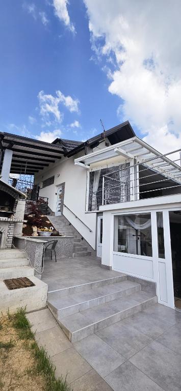 a white house with stairs in front of it at Elis in Hrašćina