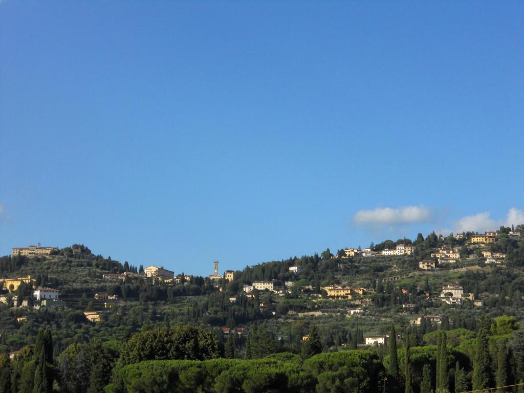 uma cidade no topo de uma colina com árvores em Villa vista Fiesole em Florença