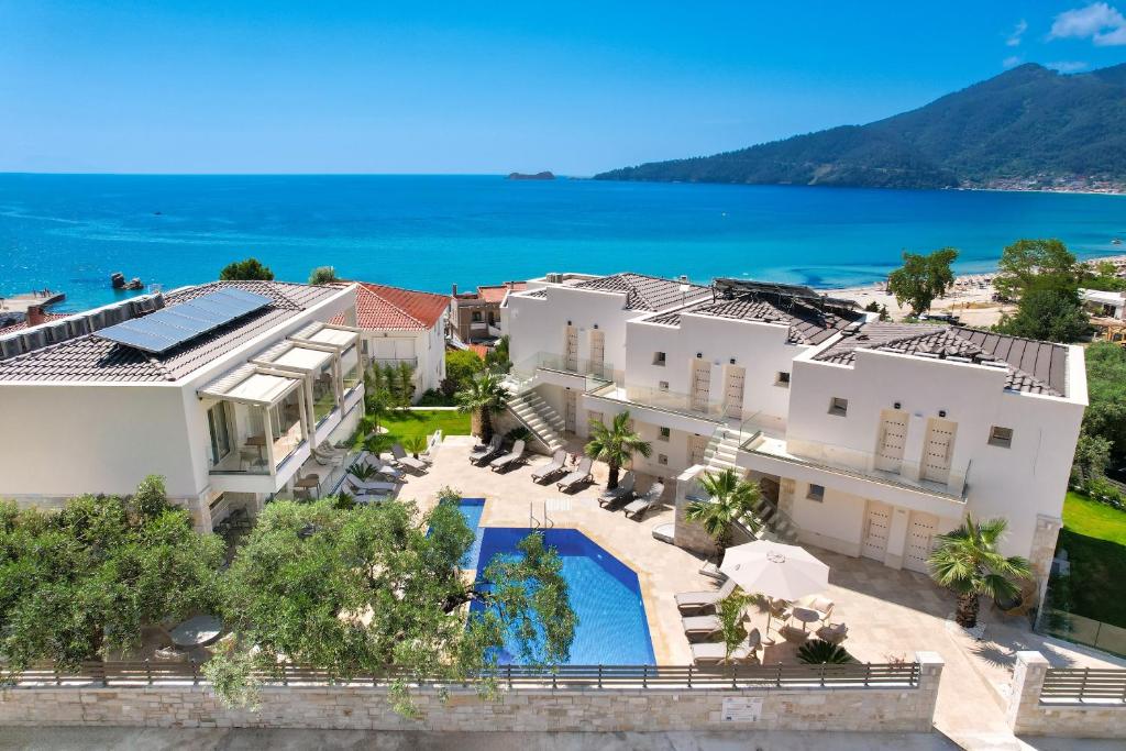 an aerial view of a house with a swimming pool at Synthea Suites in Chrysi Ammoudia
