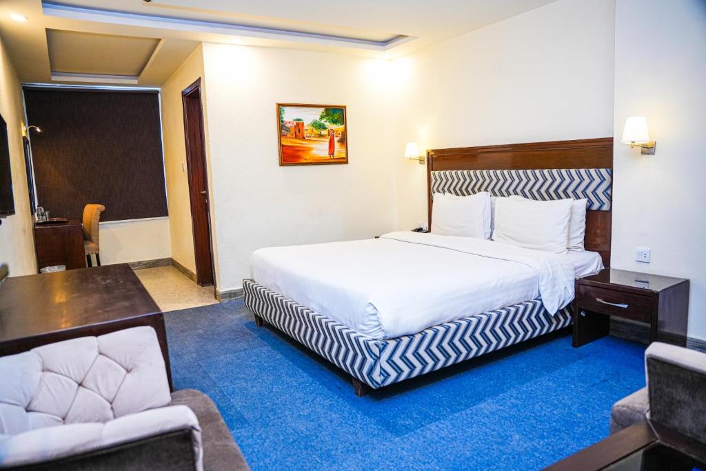 a hotel room with a bed and two chairs at Milson Hotel in Naran