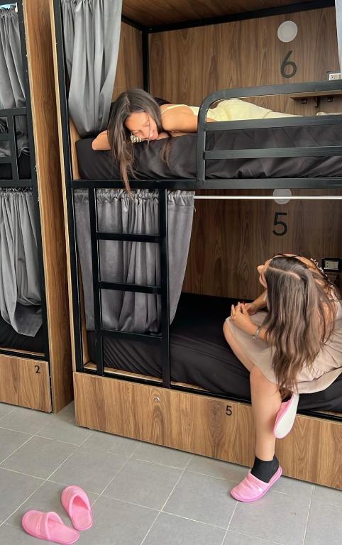 two girls sleeping on bunk beds in a room at one hostel in Tabarka