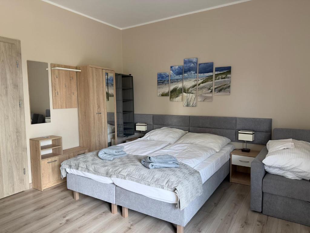 a bedroom with a bed and a chair in it at Villa Rowena in Rowy