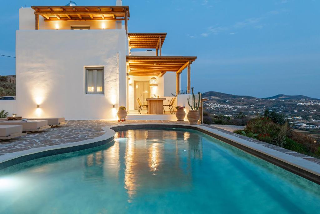 a swimming pool in front of a villa at Eartha Horizon Villas Naxos in Naxos Chora