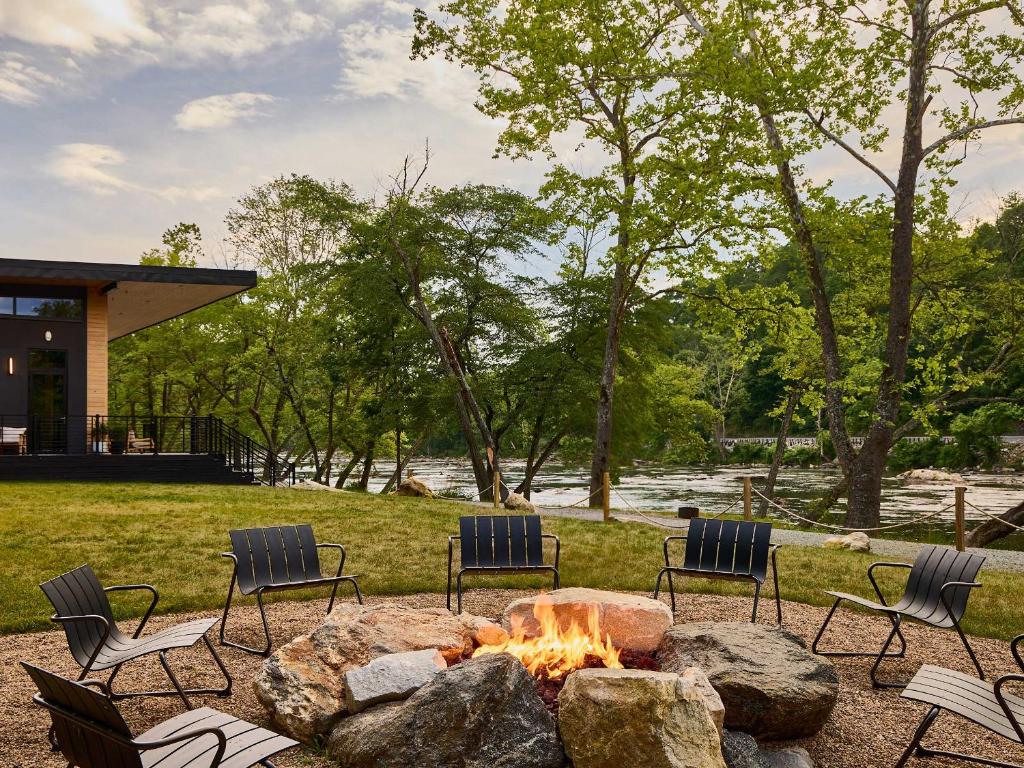 a fire pit in a yard with chairs around it at AutoCamp Asheville in Asheville