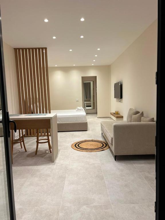 a living room with a couch and a table at Piknik Suites in Dhërmi