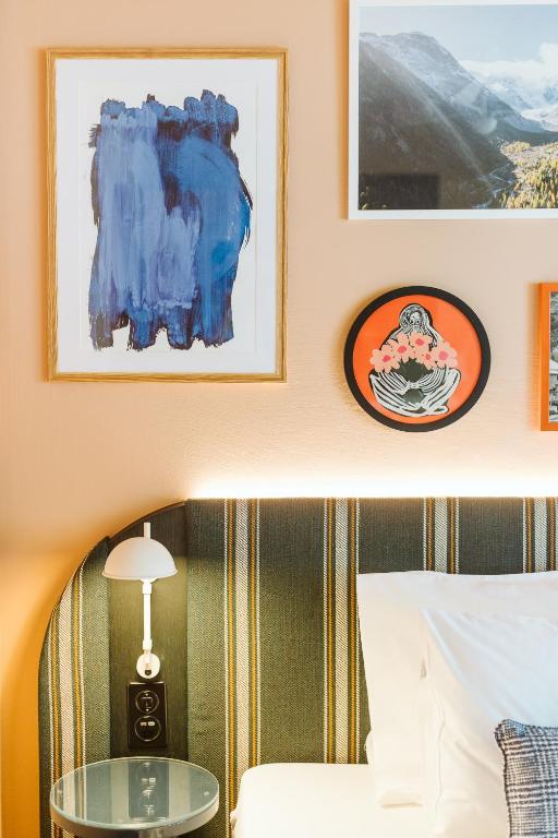 a bedroom with a bed and a glass table at Boutique Hotel Engadinerhof - A Home for Generations in Pontresina