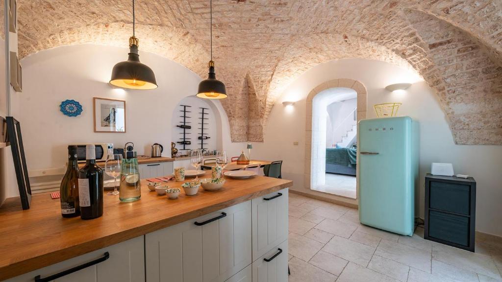 a kitchen with a blue refrigerator in a room at Casa Superga by Rentbeat in Cisternino