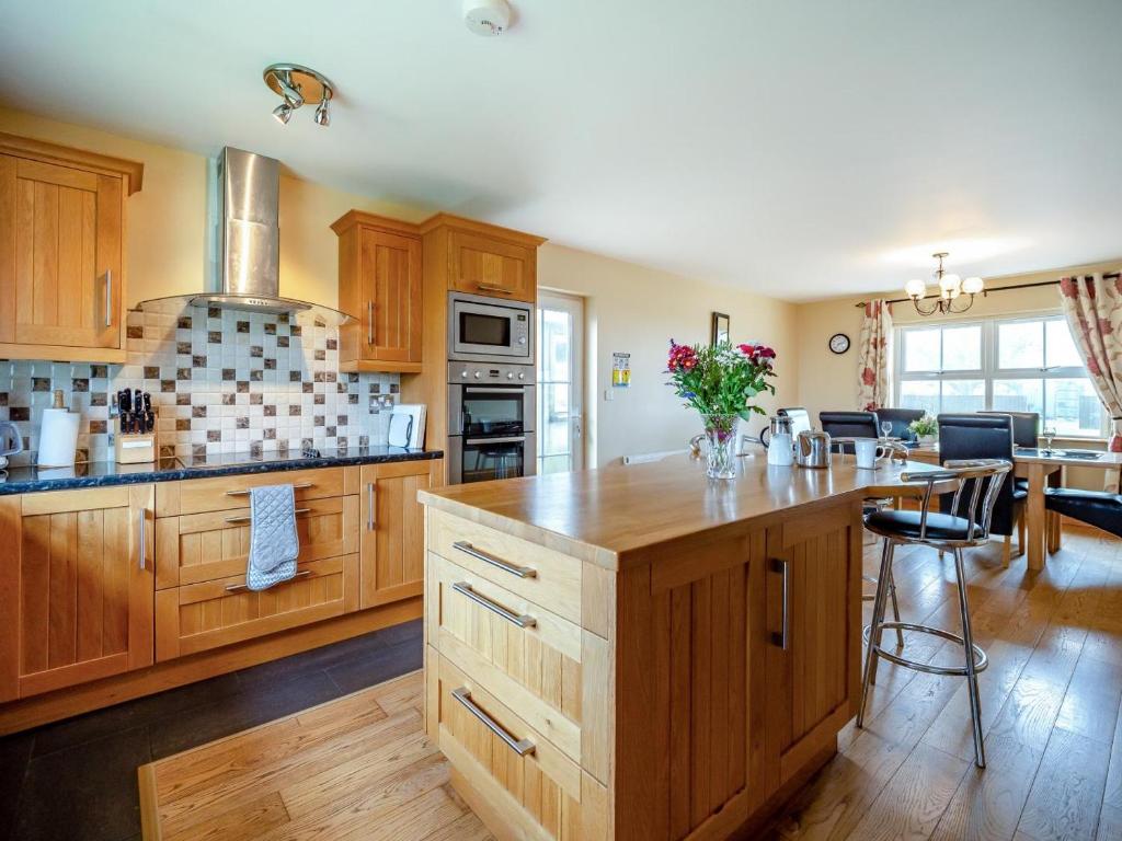 a large kitchen with wooden cabinets and a counter top at 4 Bed in Schull oc-ii09887 in Schull