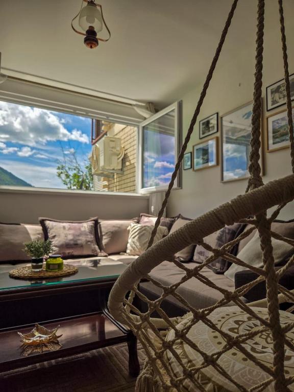 a living room with a couch and a swing at Piva Rustic Escape in Plužine