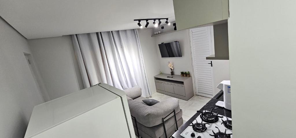 a small living room with a chair and a table at RG Kitnet02 in Curitiba