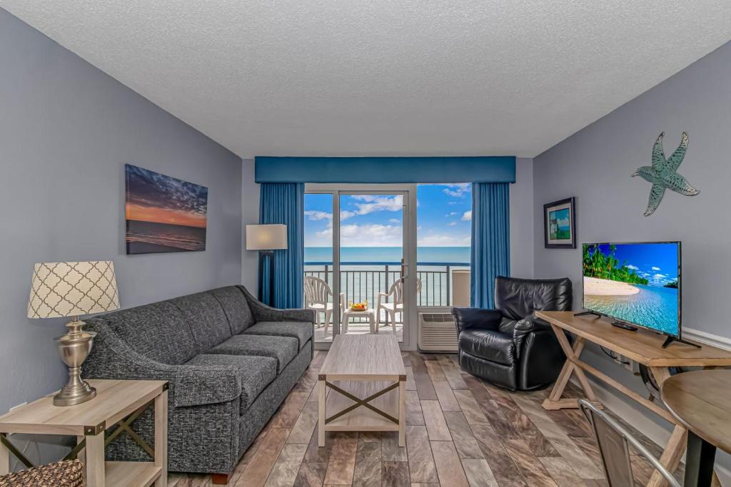 a living room with a couch and a table at Boardwalk 1030 in Myrtle Beach