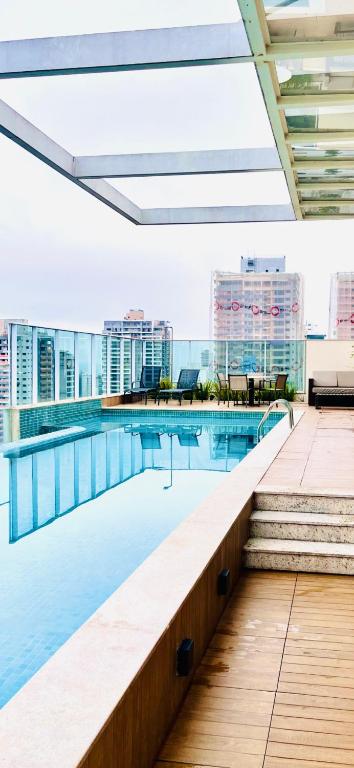 a swimming pool on the roof of a building at Dna Smart Style in Goiânia