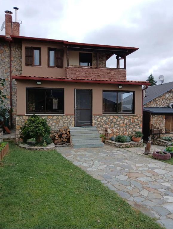 a house with a stone walkway in front of it at ARTEMIS HOME in Pétra