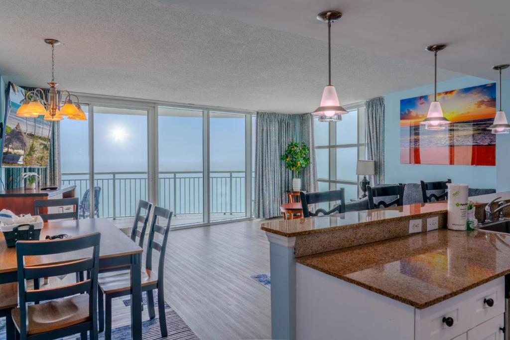 a kitchen and dining room with a view of the ocean at Sandy Beach 1612 in Myrtle Beach