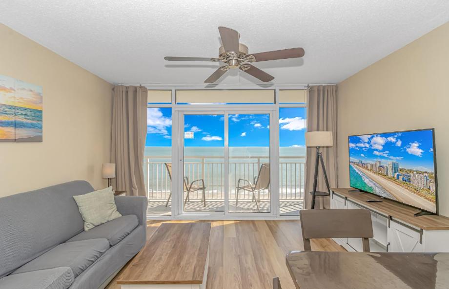 a living room with a couch and a ceiling fan at Atlantica 757 in Myrtle Beach