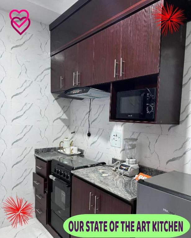 a kitchen with a stove and a microwave at Britney Luxury Apartment in Irete