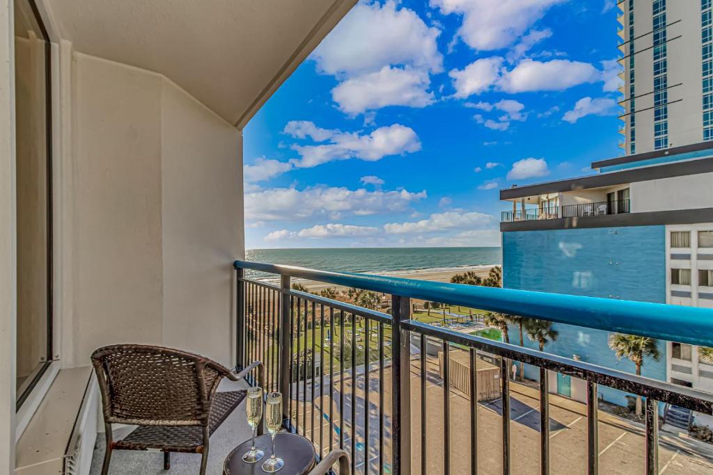 a balcony with a chair and a view of the ocean at Oceanview Studio at Boardwalk Resort 440 in Myrtle Beach