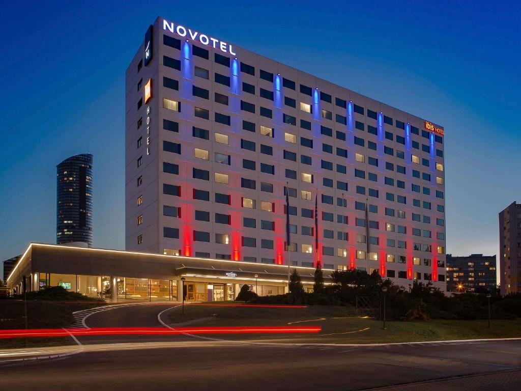 a hotel building with red and blue lights on it at Novotel Wrocław Centrum in Wrocław