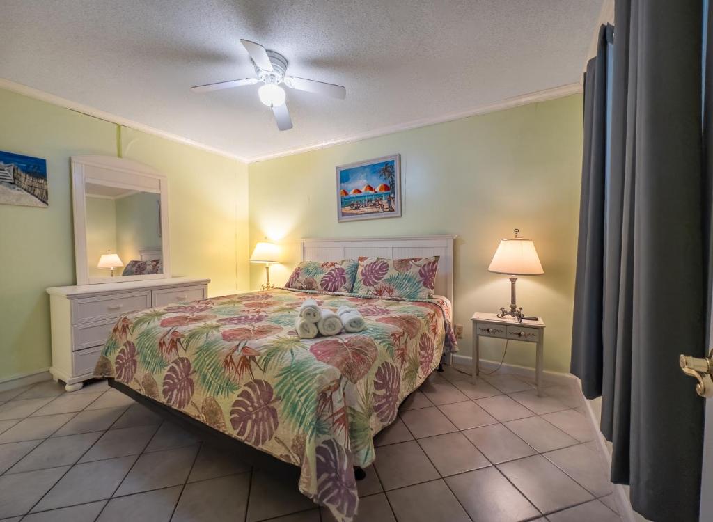 a bedroom with a bed and a ceiling fan at A Place at the Beach 406 in Myrtle Beach