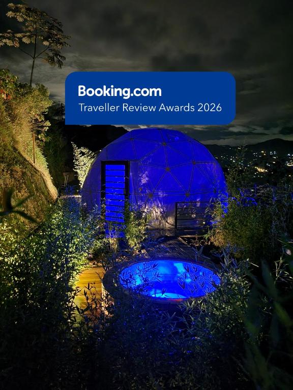 a view of a garden with a blue dome at night at Solaris Glamping Exclusive in Tena
