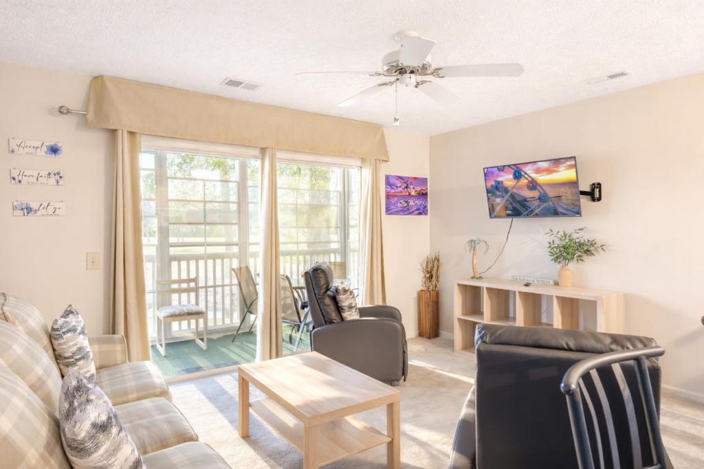 a living room with a couch and a table at Charming Golf Getaway! River Oaks 19E in Myrtle Beach