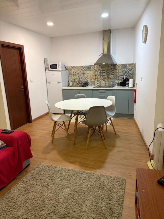 a kitchen with a table and chairs in a room at Kasa102 in Gouveia