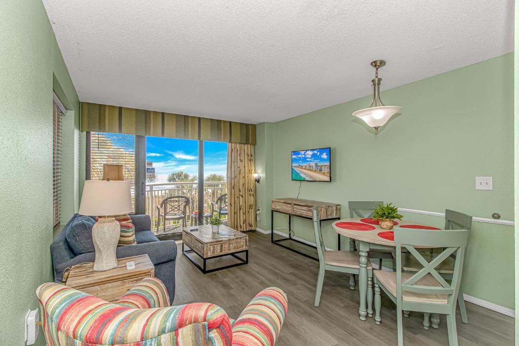 a living room with a couch and a table at Updated 2nd Floor 1BR for 4! Sailfish 210 in Myrtle Beach
