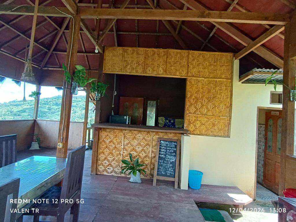 a restaurant with a bar in a building at Watuburu Cottage & Restaurant in Ende