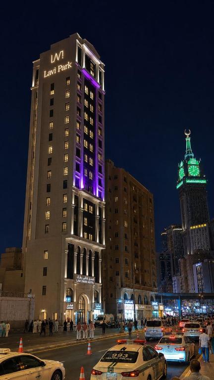 a large building with purple lights on top of it at فندق لافي بارك in Mecca