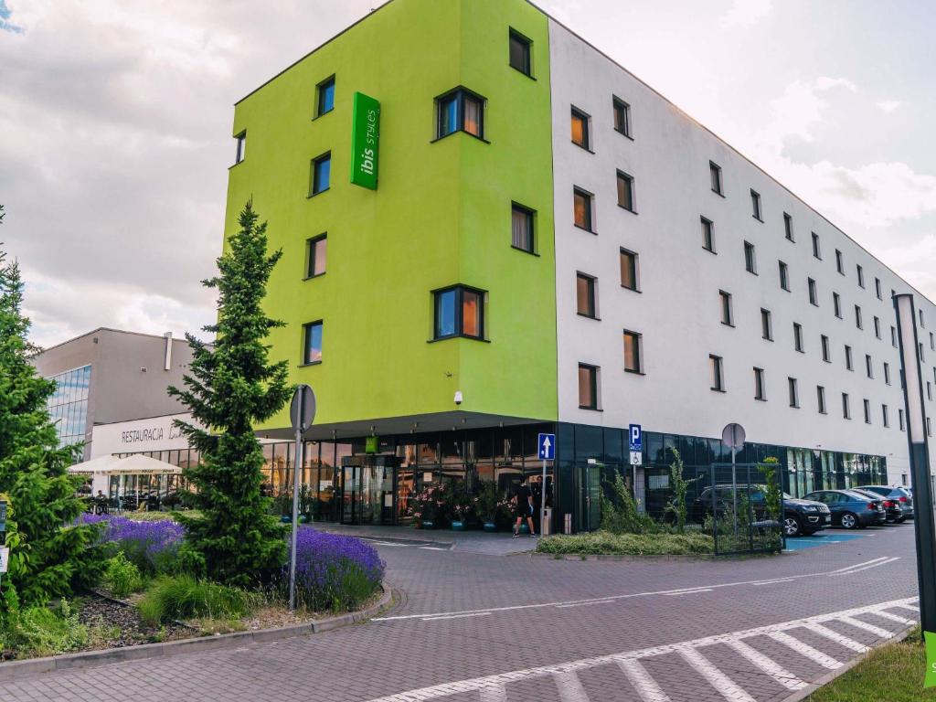 a yellow and white building on a street at ibis Styles Siedlce in Siedlce