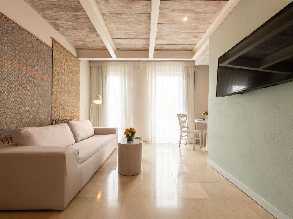 a living room with a white couch and a table at Hotel Boutique Bovedas de Santa Clara By Accor in Cartagena de Indias