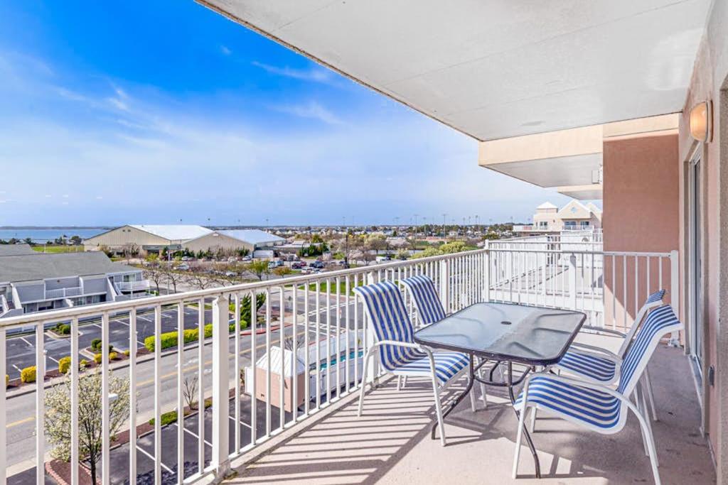 a balcony with chairs and a table and a view of the ocean at Lorelei I 404 in Ocean City