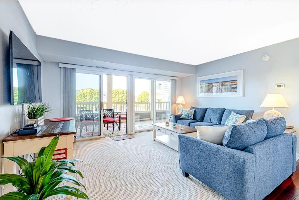 a living room with a blue couch and a television at Heron Haven in Ocean City