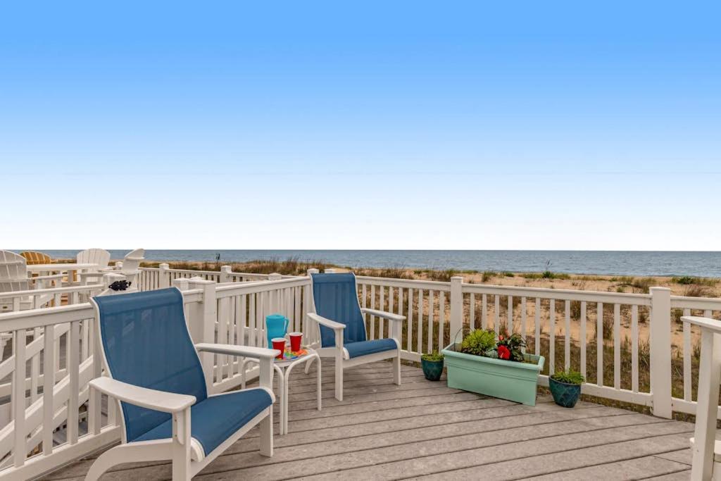 two chairs on a deck next to the beach at Beach Village 6 in Ocean City