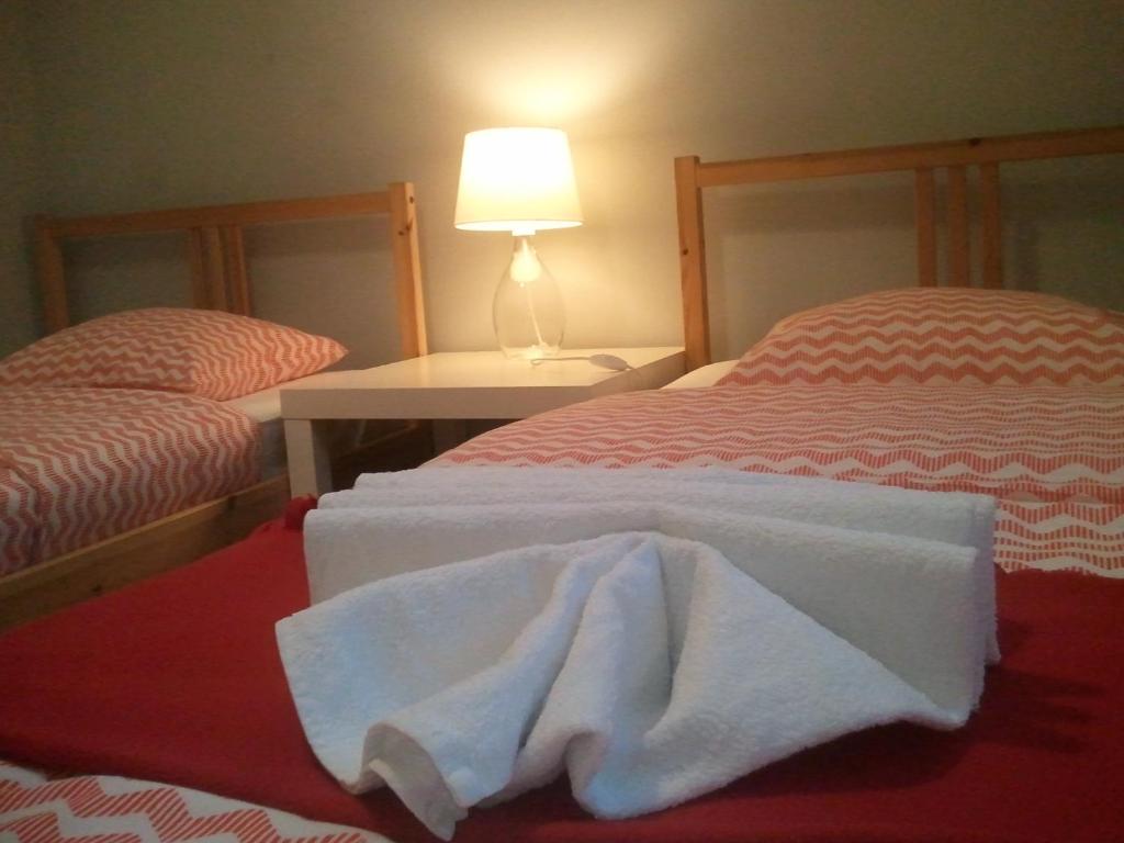 two beds with white towels on them in a room at FRESCO PLUS -Filharmonia in Łódź