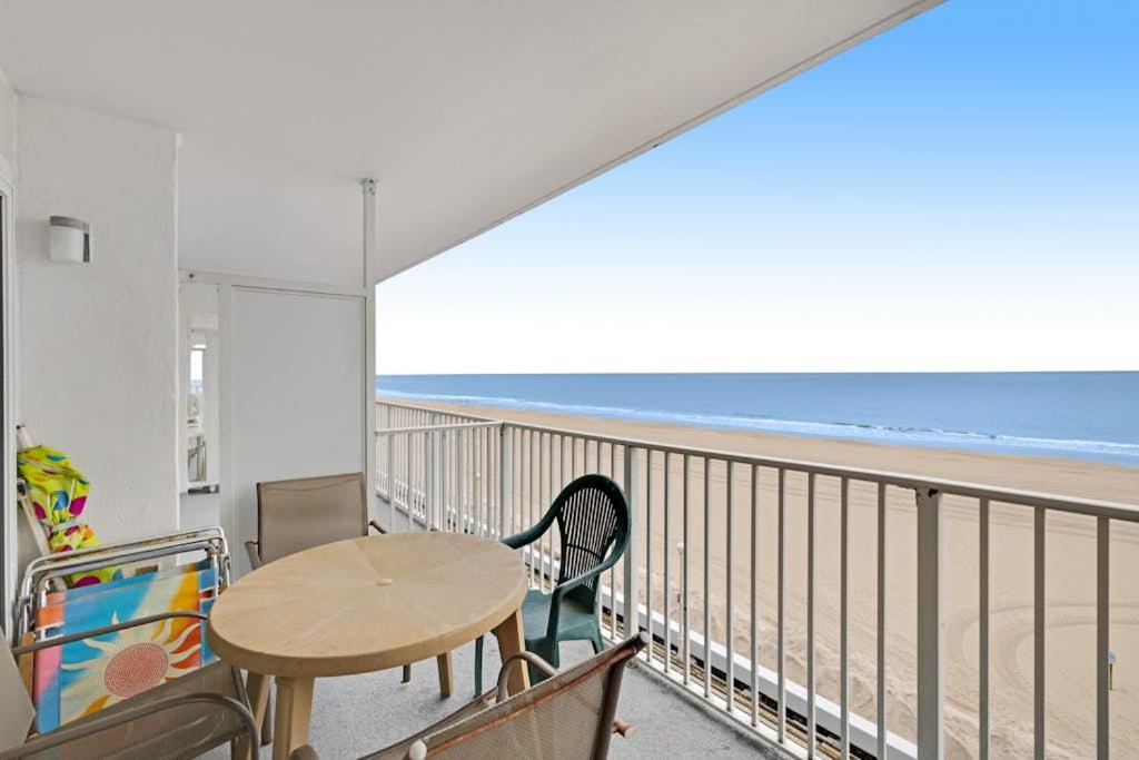 a table and chairs on a balcony with the beach at El Capitan 403 in Ocean City