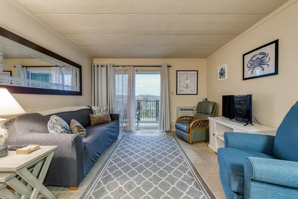 a living room with a couch and a tv at Constellation House 107 in Ocean City
