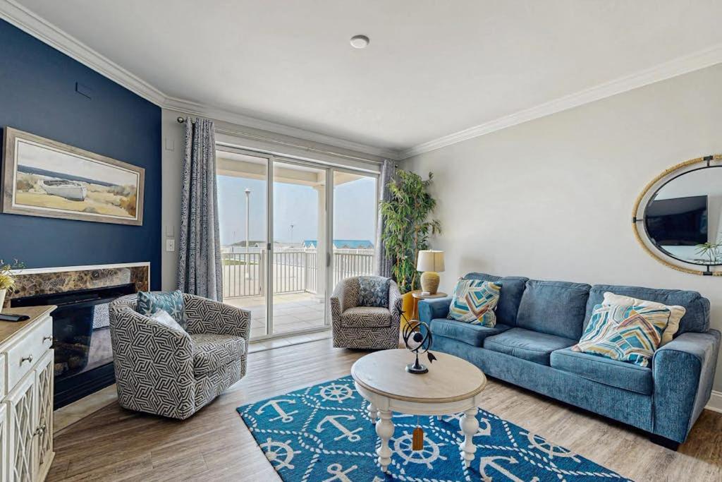 a living room with a blue couch and chairs at Belmont Towers 410 in Ocean City