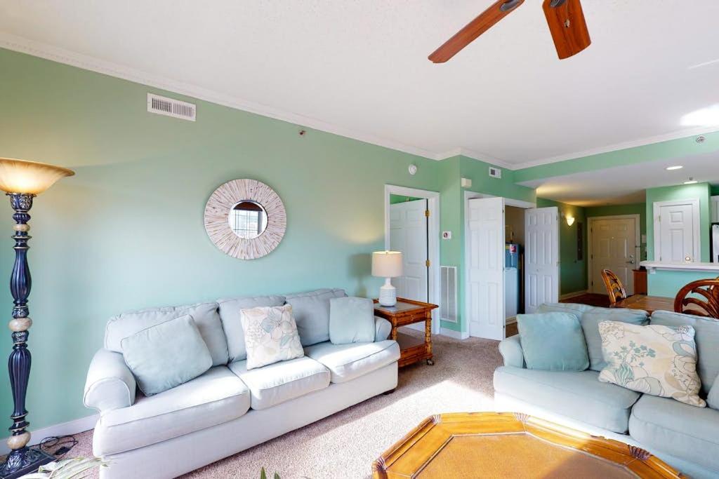 a living room with a white couch and a table at Sunset Bay III 313 in Ocean City