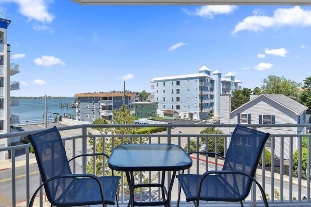 a balcony with chairs and a table and a view of the water at Bahia Vista II 305 in Ocean City