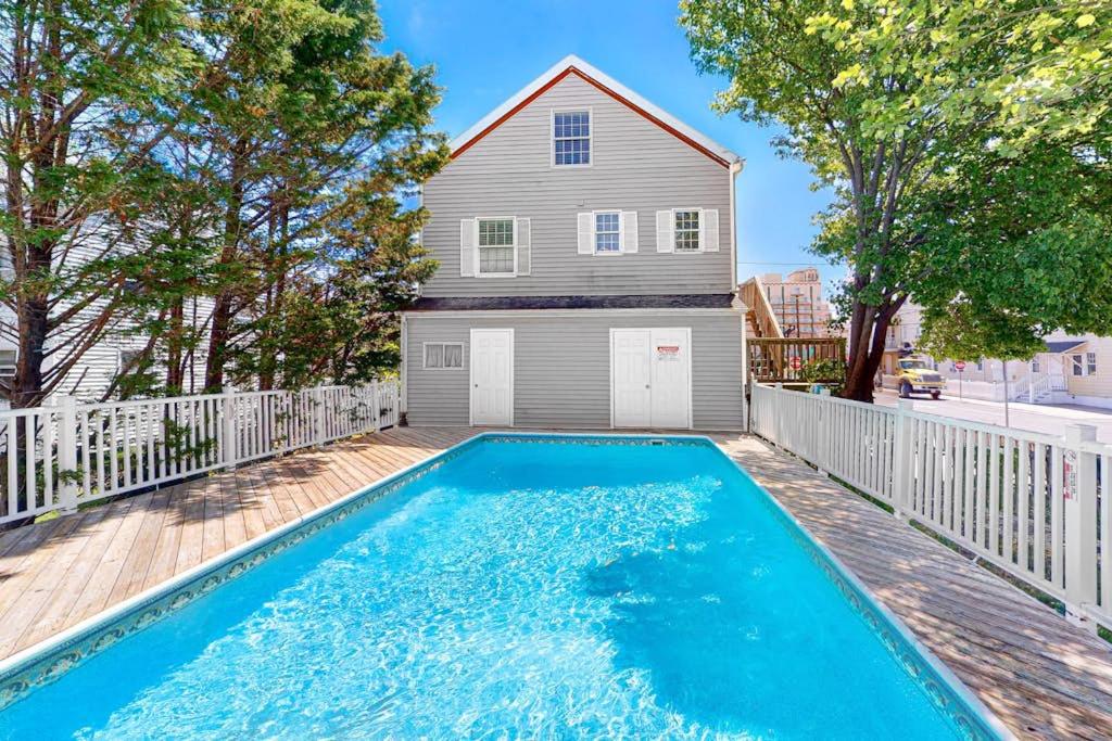 a house with a swimming pool in front of a house at 900 Philadelphia in Ocean City